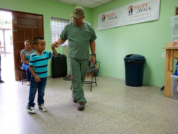 Helping a child walk with his new prosthetic. (Photo: Hope to Walk)